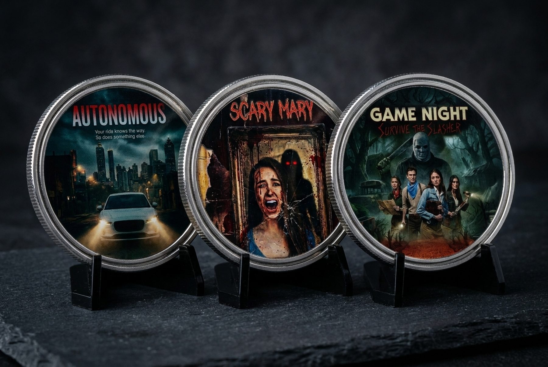 Three HorrorCoin collectible challenge coins: Autonomous, Scary Mary, and Game Night